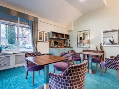Bright common area with seating and coffee station