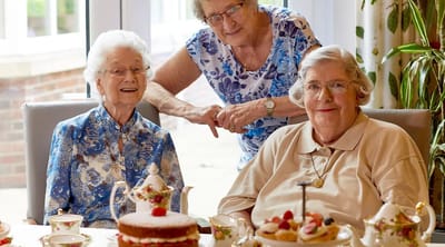 Residents enjoying tea and cake during a celebration
