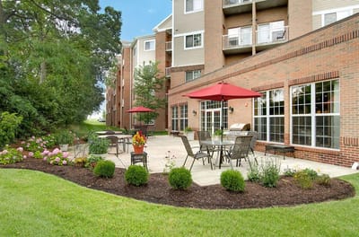 Patio area with red umbrellas and flowers