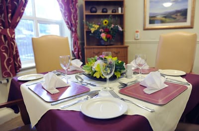 Well-set dining table with floral centerpiece