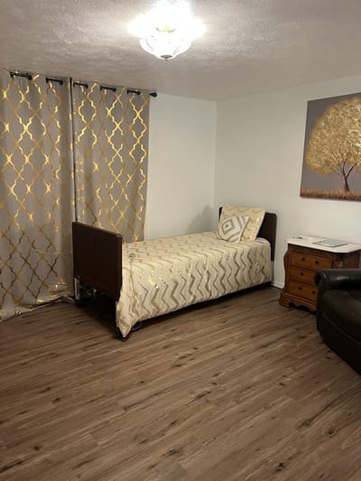 A well-furnished private resident room with a bed