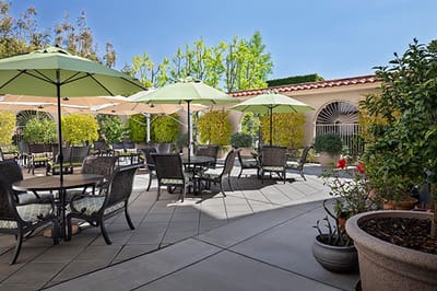 Outdoor dining area with green umbrellas and seating
