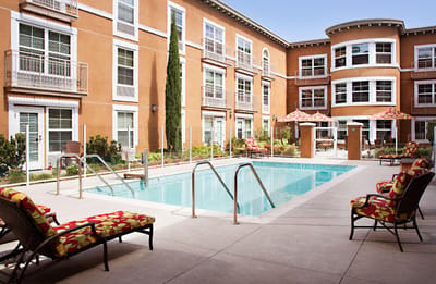 Outdoor pool area with lounge chairs and umbrellas