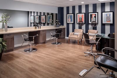 Interior of a hair salon with styling chairs and artwork