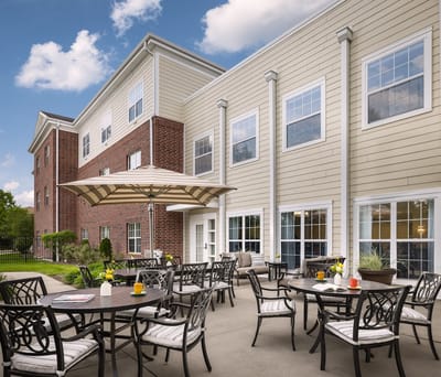 Patio area with tables and chairs outside the senior living facility
