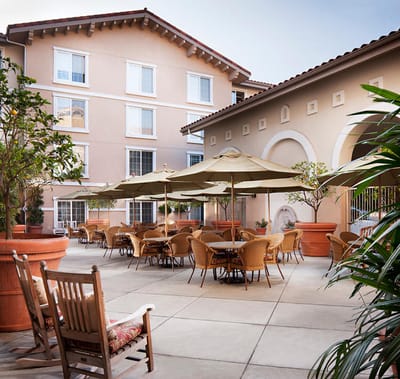 Outdoor patio area with tables and umbrellas