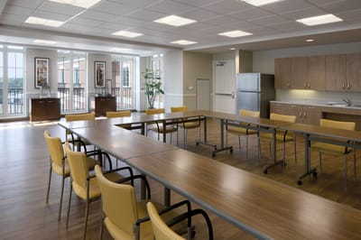 Bright, spacious common area with tables and chairs