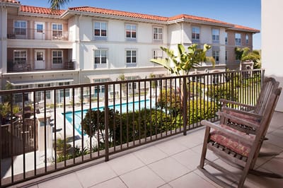 View of a balcony with outdoor space overlooking a garden