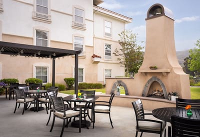 Outdoor seating area with a fireplace and tables