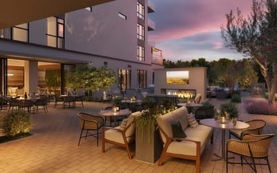 Outdoor seating area with a firepit at sunset