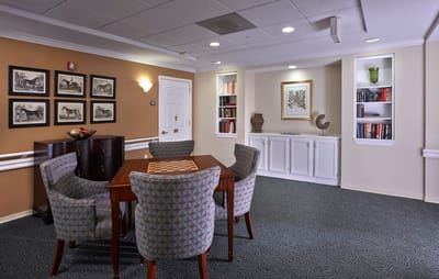 A cozy common area with seating and bookshelves