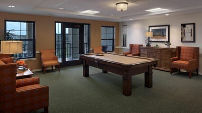 Bright common area with seating and a pool table
