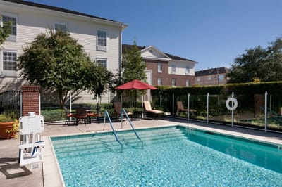 Outdoor pool area with lounge chairs and umbrellas