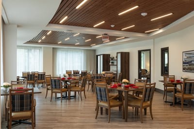 Bright dining area with tables and chairs set up
