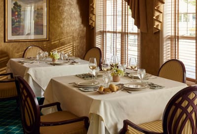 Elegant dining room setup with table settings and natural light