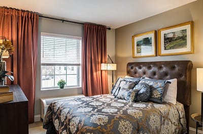 Cozy private resident room with a decorated bed