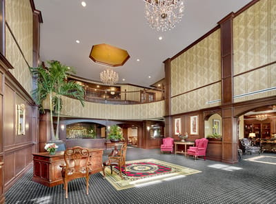 Interior view of a welcoming lobby with chandeliers