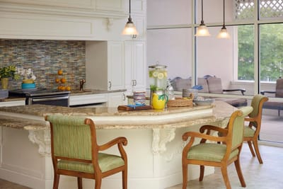 Bright kitchen area with granite island and seating