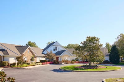 Exterior view of a senior living facility with landscaped entry