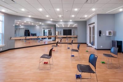 Empty activity room with chairs and weights