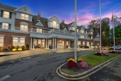 Exterior view of Brighton Gardens facility at dusk