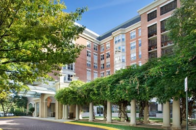 Exterior view of Brighton Gardens with landscaped entrance