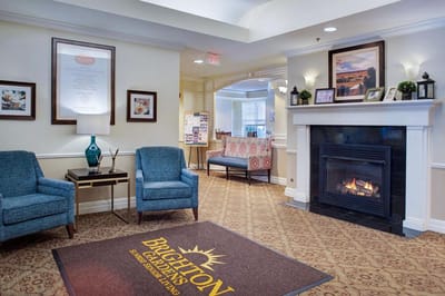 Bright interior common area with seating and fireplace