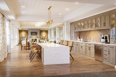 Modern dining room with large table and kitchen area