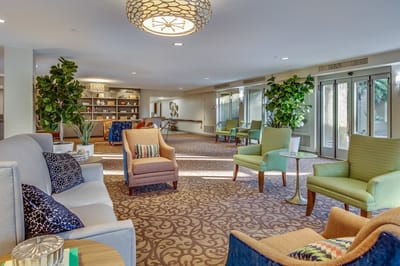 Bright common area with comfortable seating and plants