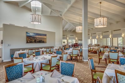 Dining room with tables and chairs arranged for meals