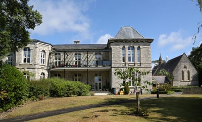 Exterior view of Brompton Court with gardens