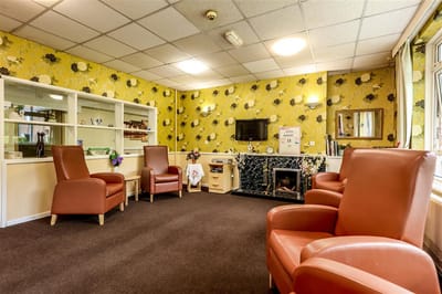 Lounge area with comfortable chairs and floral wallpaper