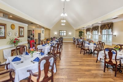 Dining room set for a meal with floral centerpieces