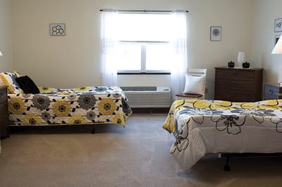 A cozy resident room with floral bedding