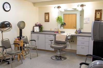 Hair salon area with styling chair and waiting area