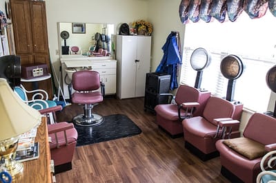 Hair salon area with styling chairs and mirrors