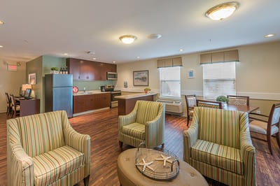 Bright interior common area with seating and kitchen