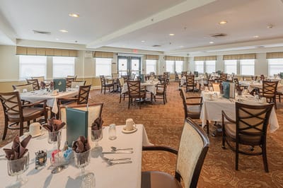 Bright dining room with tables set for meals