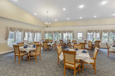 Bright dining room with tables set for meals