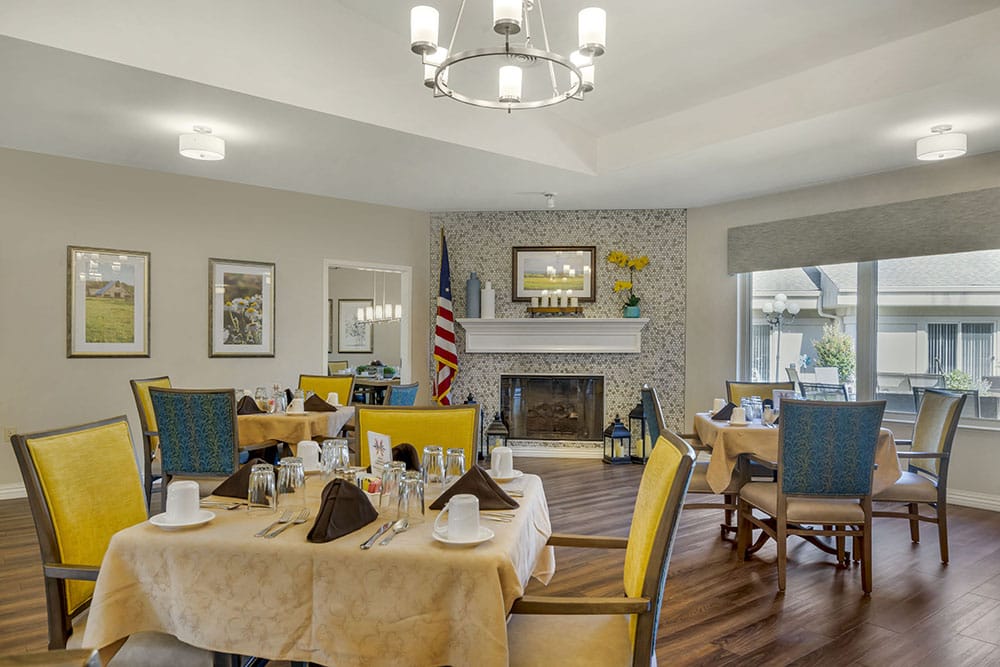 Bright dining room with tables set for a meal