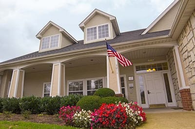 Front entrance of Brookdale Columbia with landscaping and flag