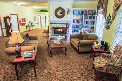 Cozy common area with seating and bookshelf