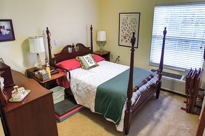 Cozy private resident room with bed and furnishings