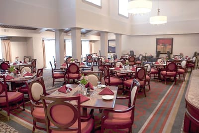 Dining room setup with elegant tables and chairs