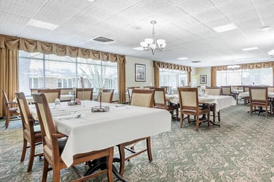 Dining room with tables and chairs set for a meal