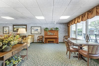Bright common area with piano and seating