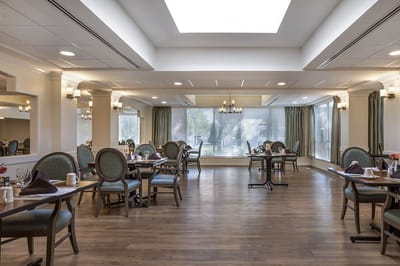 Bright dining room with tables set for meals