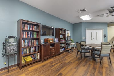 Common area with shelves, tables, and seating