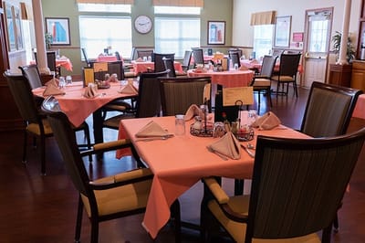 Dining room with neatly arranged tables and settings