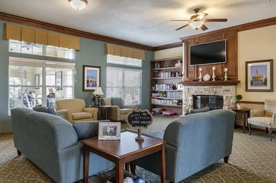 A cozy lounge area with seating and a fireplace